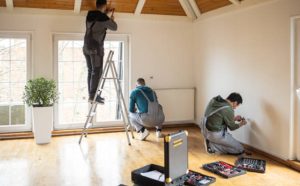 Professional repairmen working inside a client’s home
