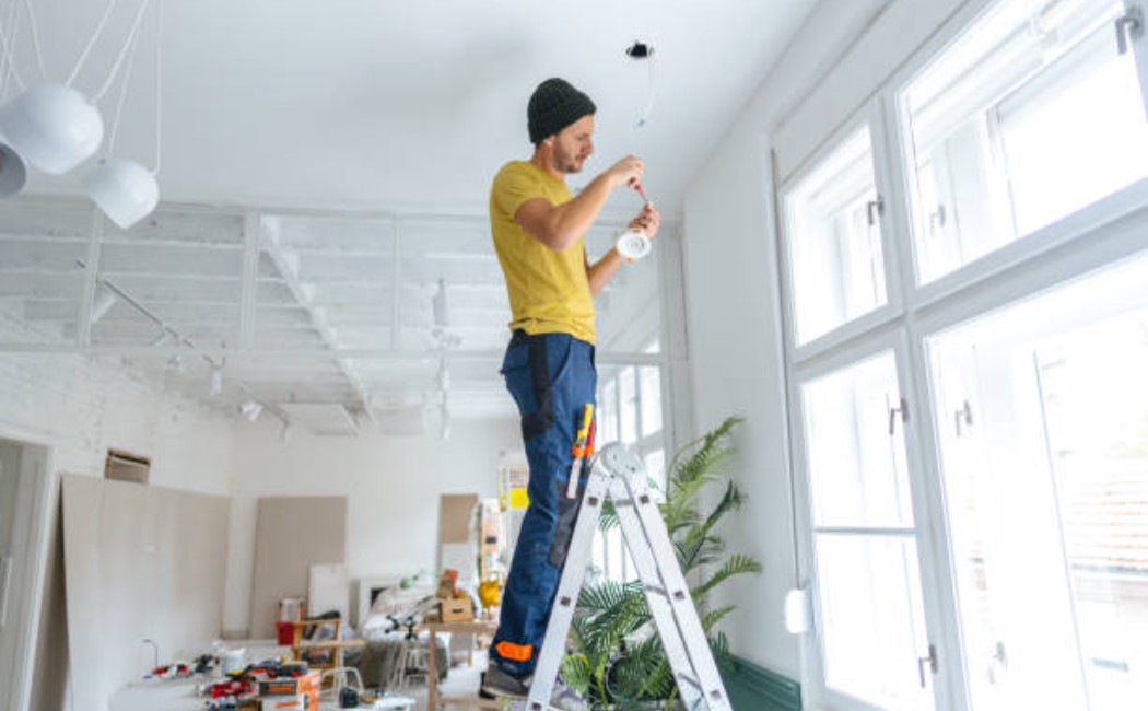 Professional installing lighting in ceiling