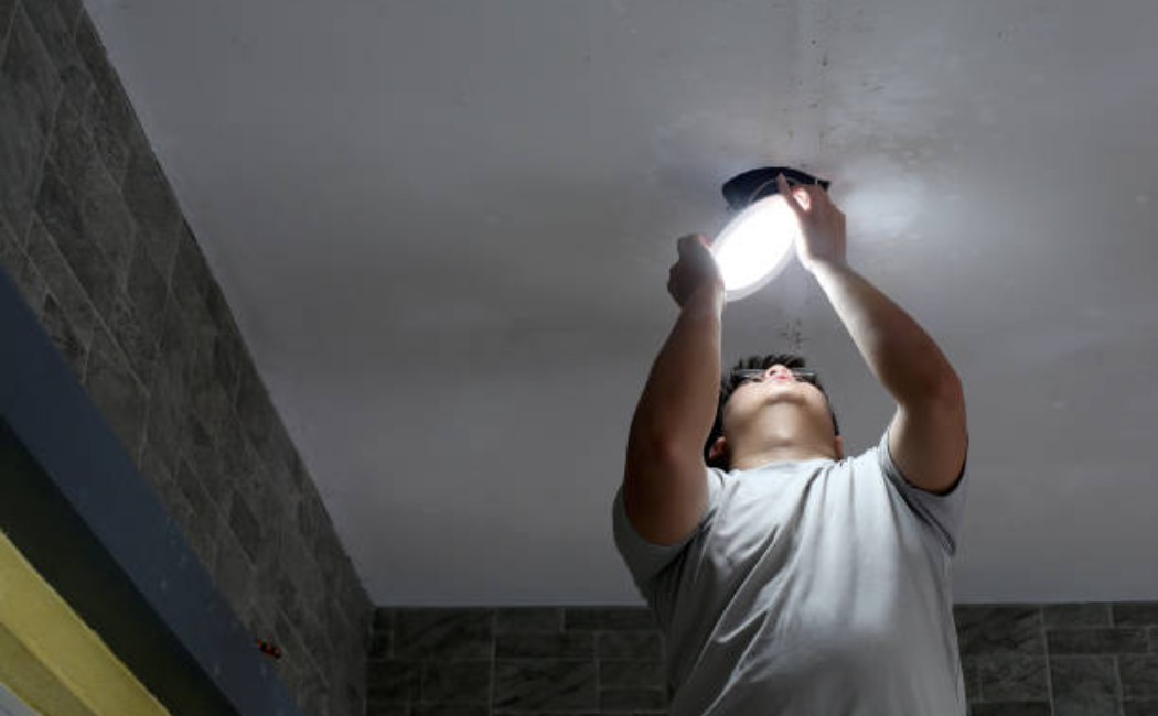 Maintenance professional at work in home lighting Installation