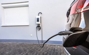Modern electric vehicle charging at a sleek wall-box station