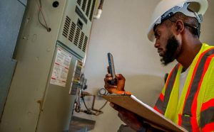 Professional air conditioning service in a garage setting