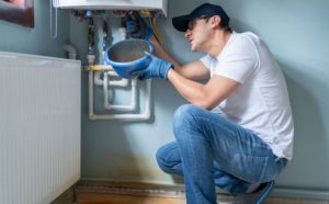 Broken gas heating boiler panel exposed in a maintenance mess