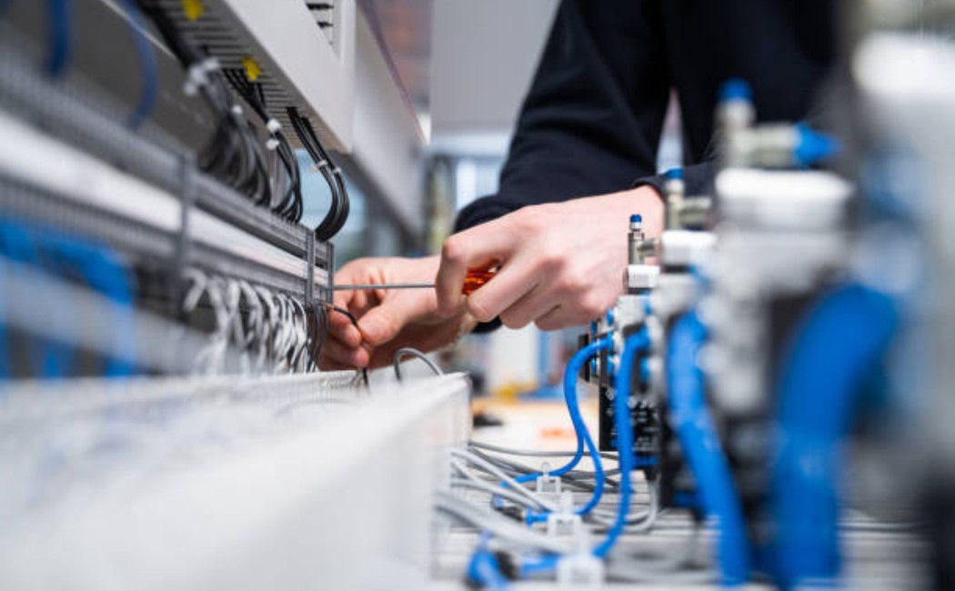 Interior of an electrical repair shop with a worker.