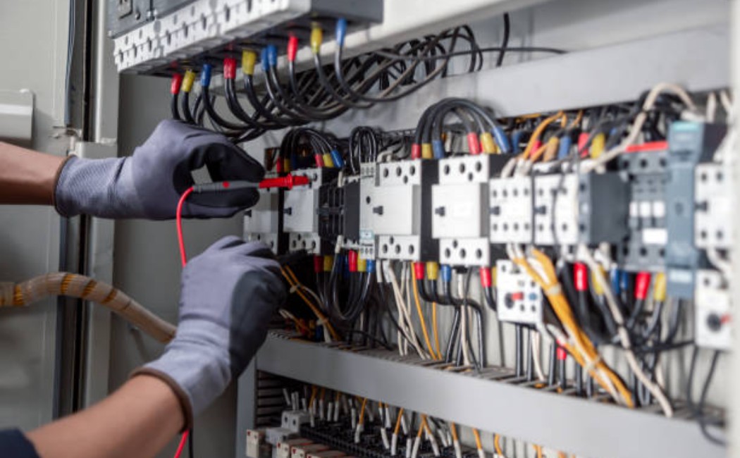 Industrial electrician performing electrical maintenance