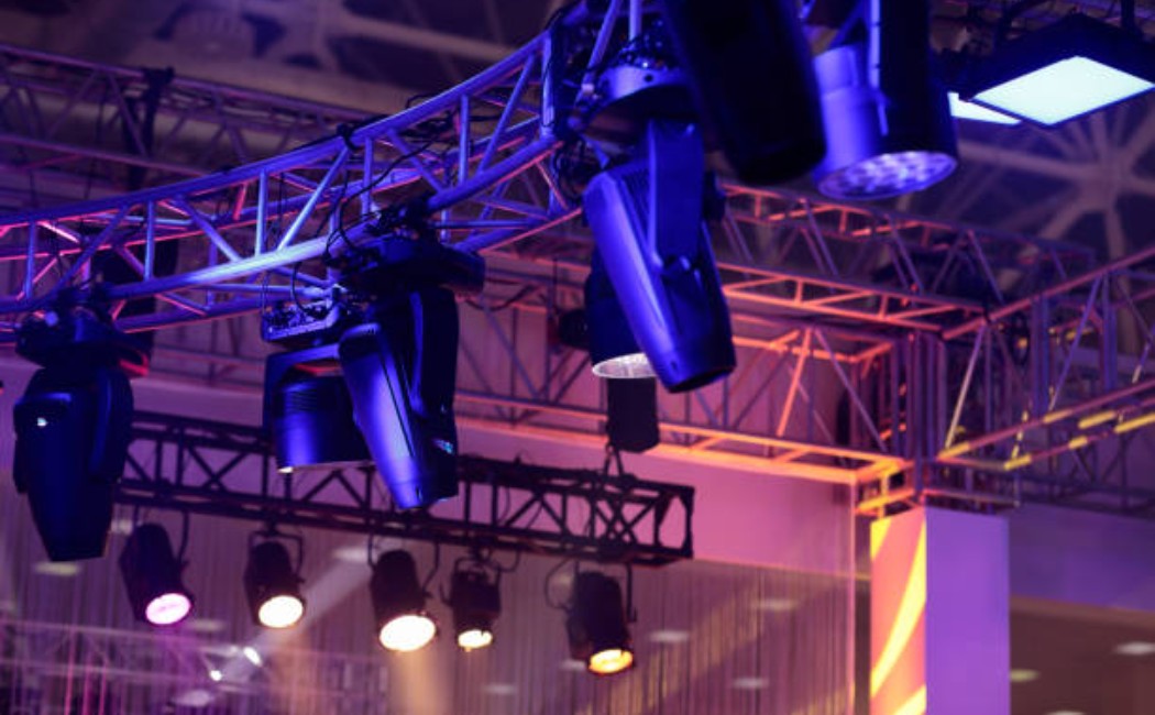 Industrial metal truss rigging with professional stage lighting setup.