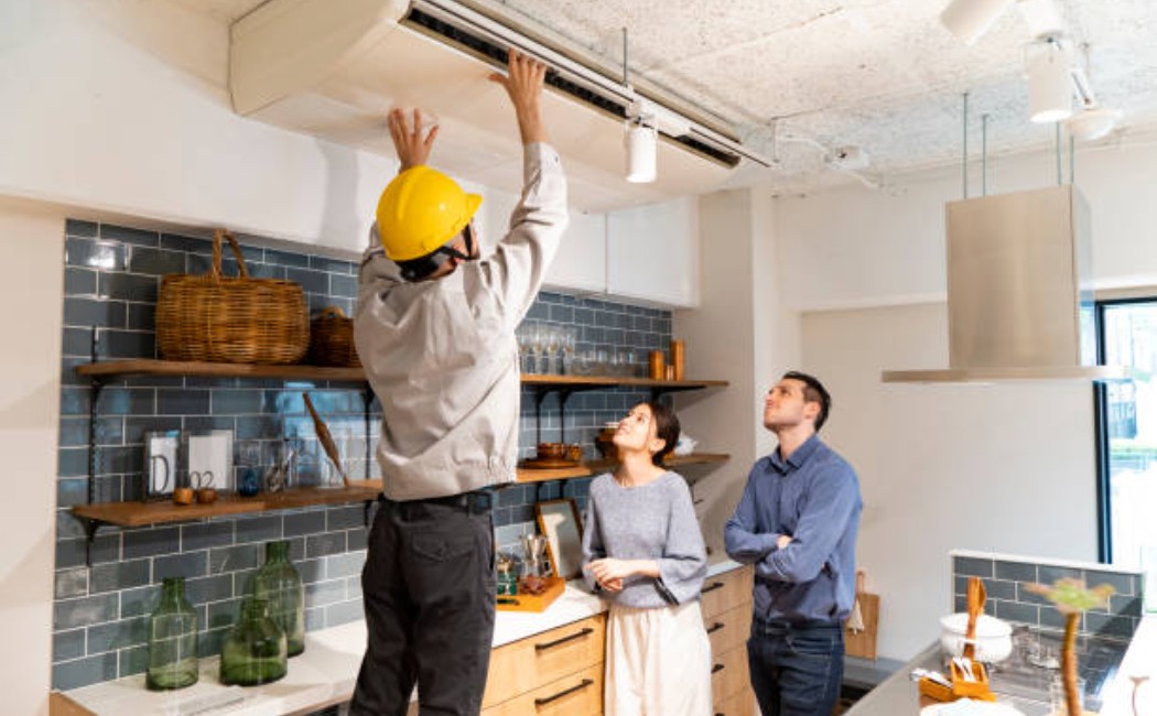 Technician inspecting a home air conditioning unit.
