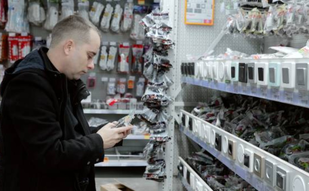 Electrician checking a labeled light switch in a store